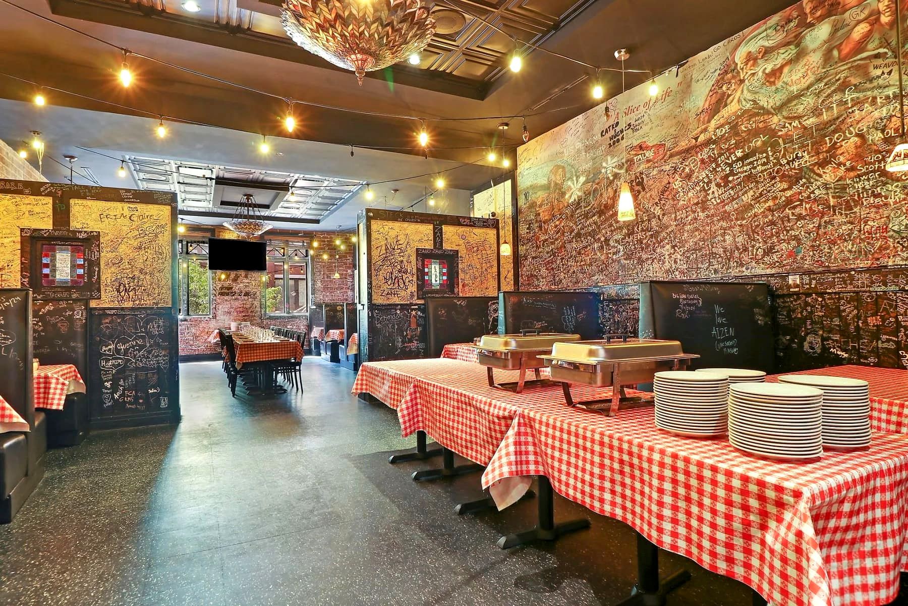Graffiti-covered private dining room at Gino's East Magnificent Mile set up for a catered event
