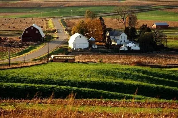Rural farmland with houses and barns aerial view