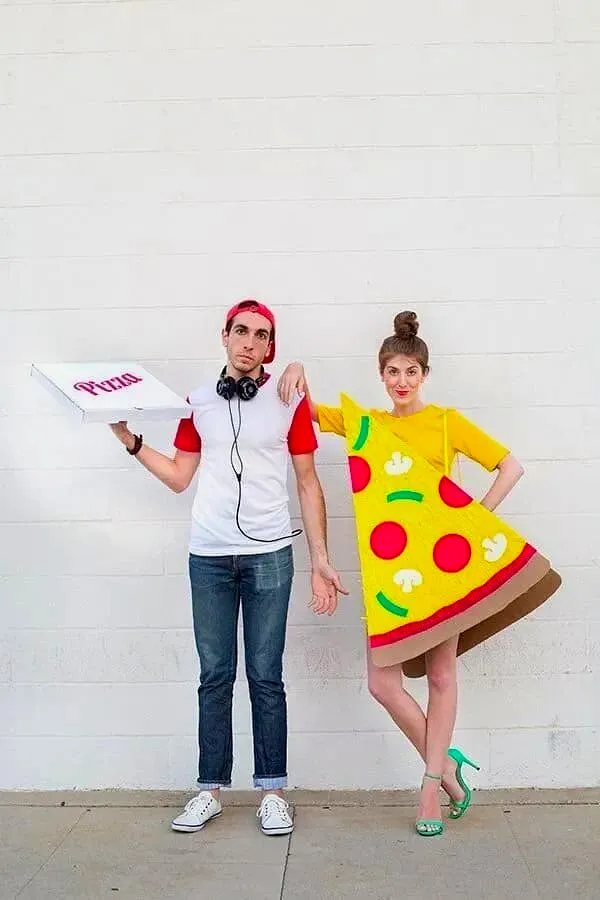 Man holding a pizza box next to a woman wearing a pizza slice costume