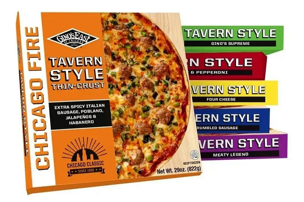 Gino’s East Tavern Style thin crust pizza box with assorted flavor packages in the background