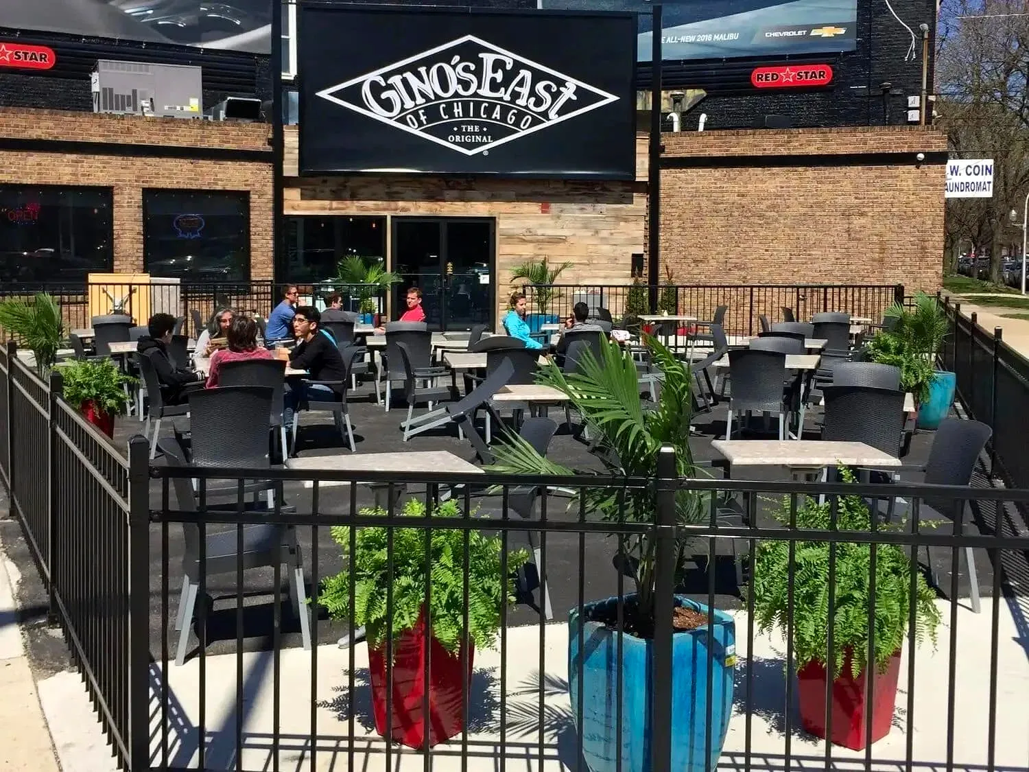 Gino's East restaurant exterior with storefront sign and outdoor patio seating