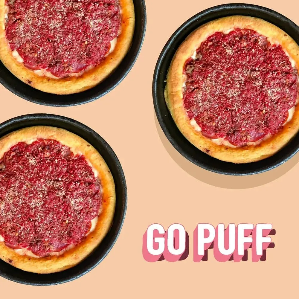 Three frozen deep dish pizzas in tins next to the GoPuff logo