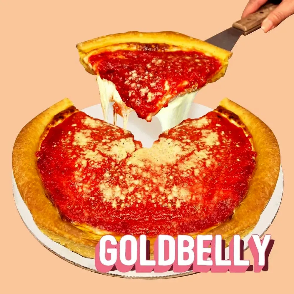 A cheesy slice of deep dish being lifted from a whole pie, with the Goldbelly logo