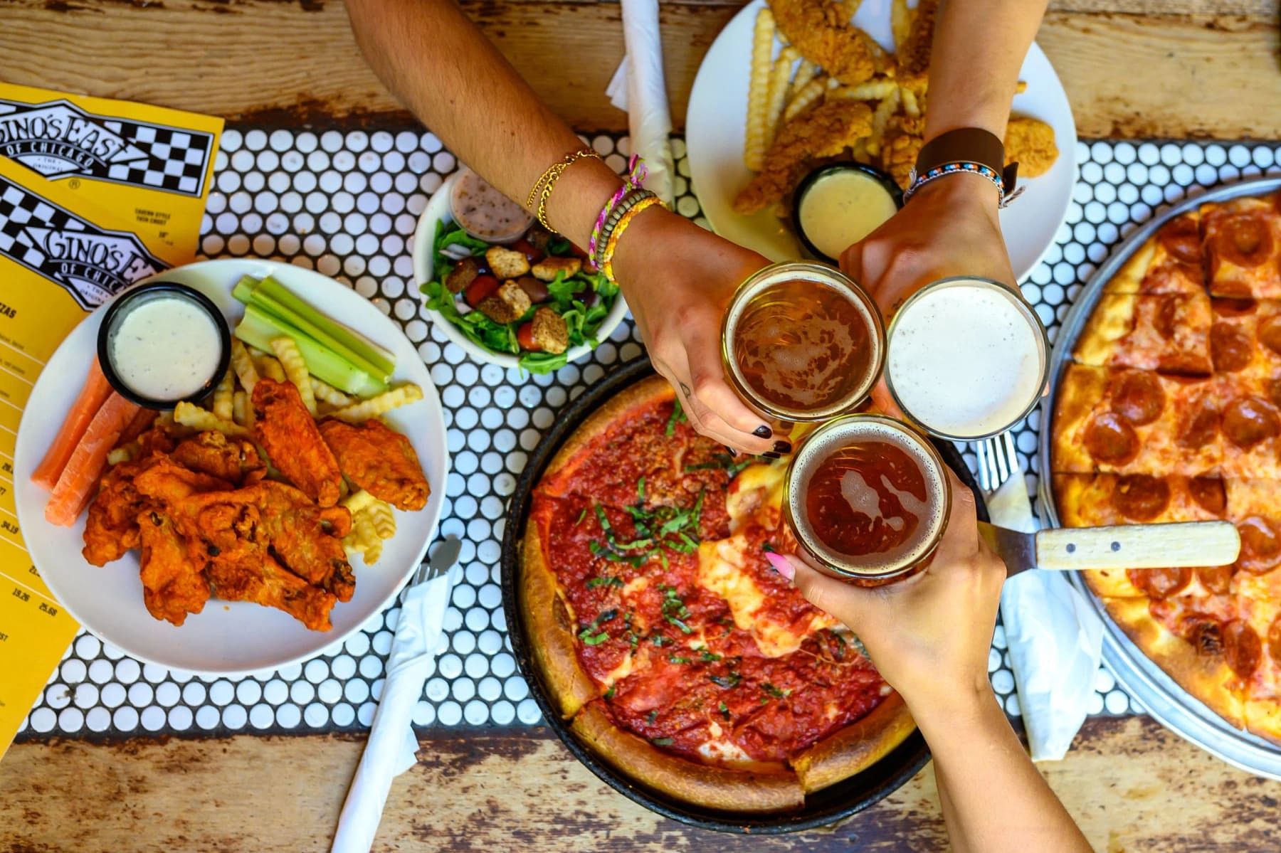 A spread of Gino's East menu items on a table