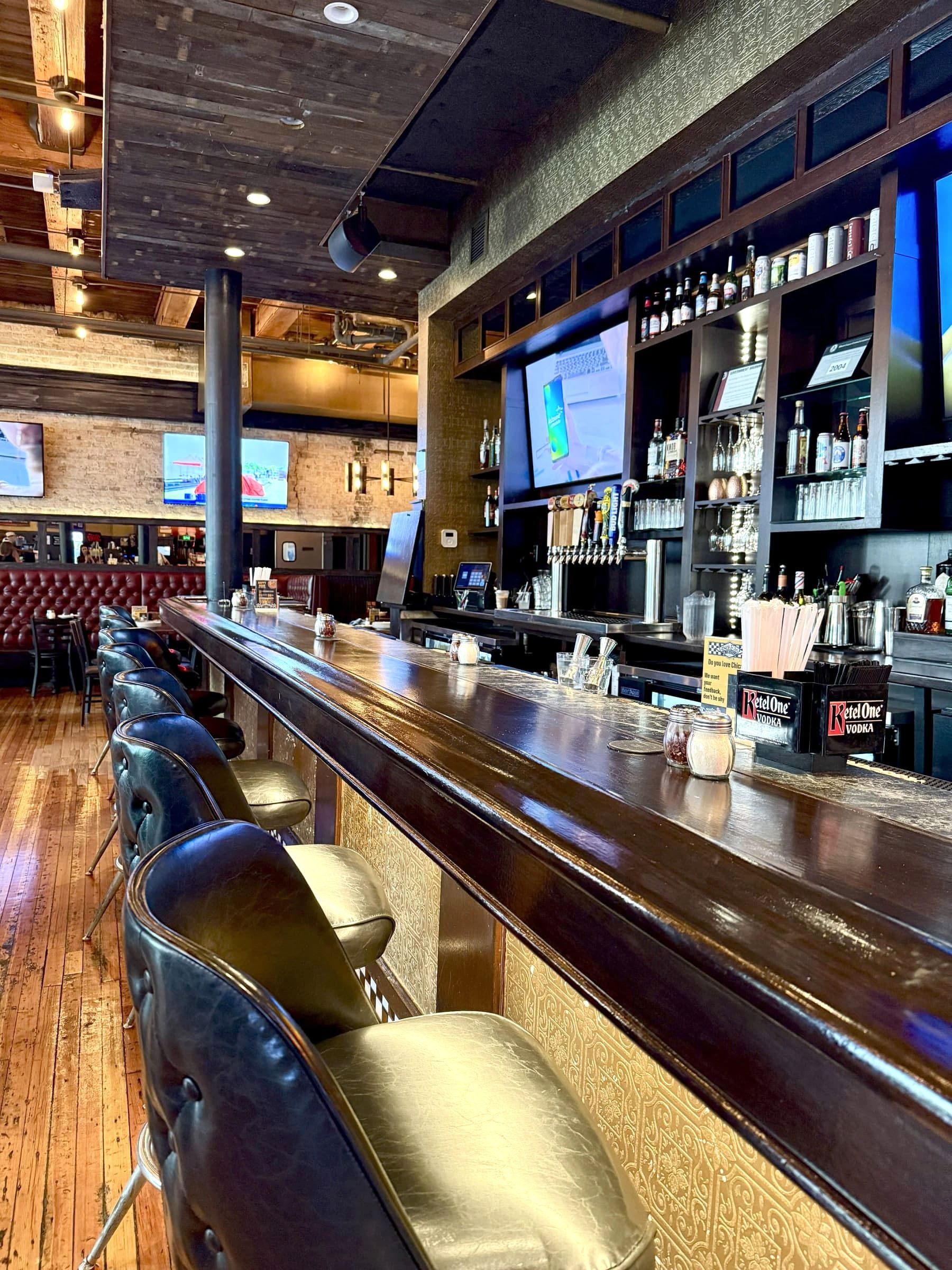 Bar seating and taps at Gino's East South Loop