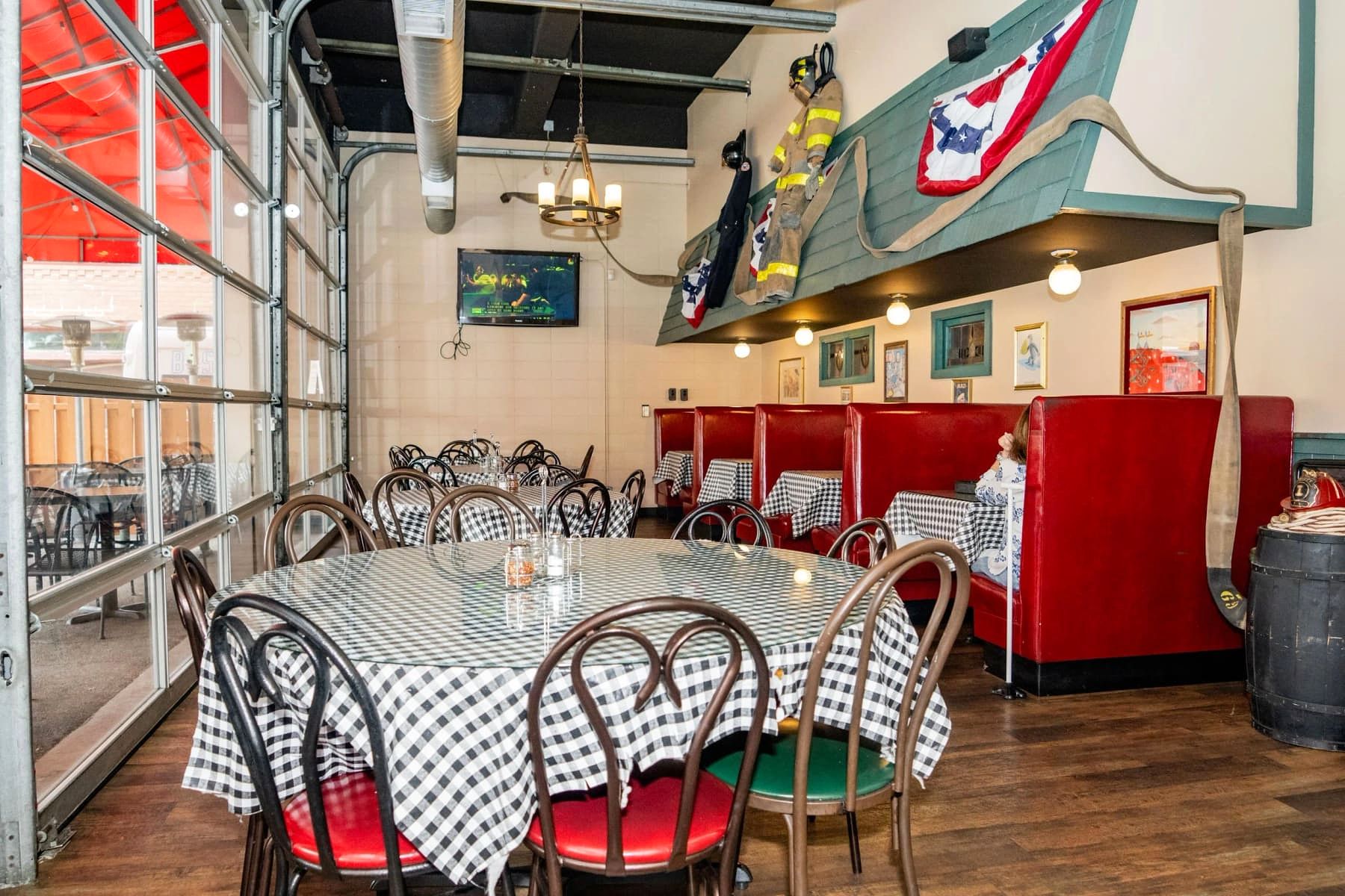 Booth seating with stained-glass windows and a vintage photo at Gino's East Wheaton