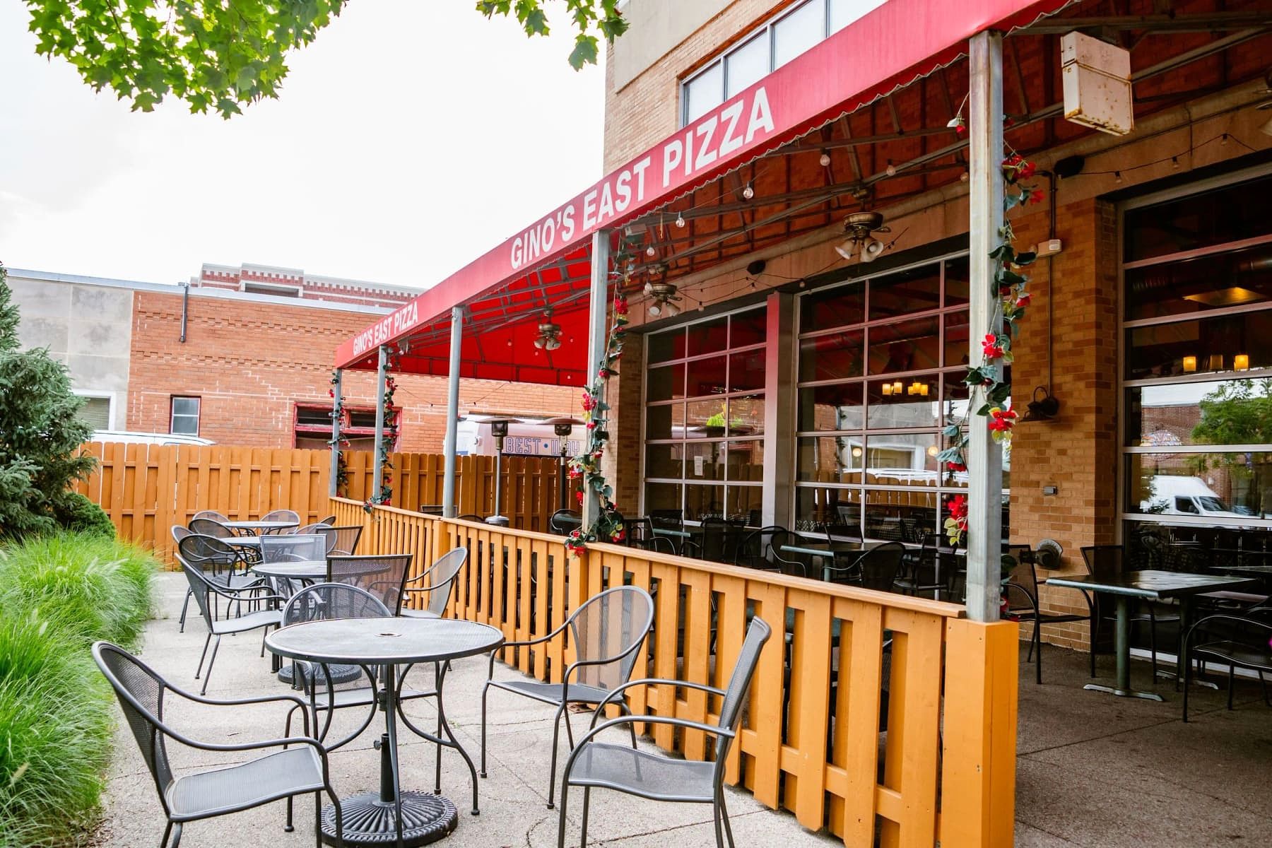 Covered outdoor patio at Gino's East Wheaton with string lights and patio heaters