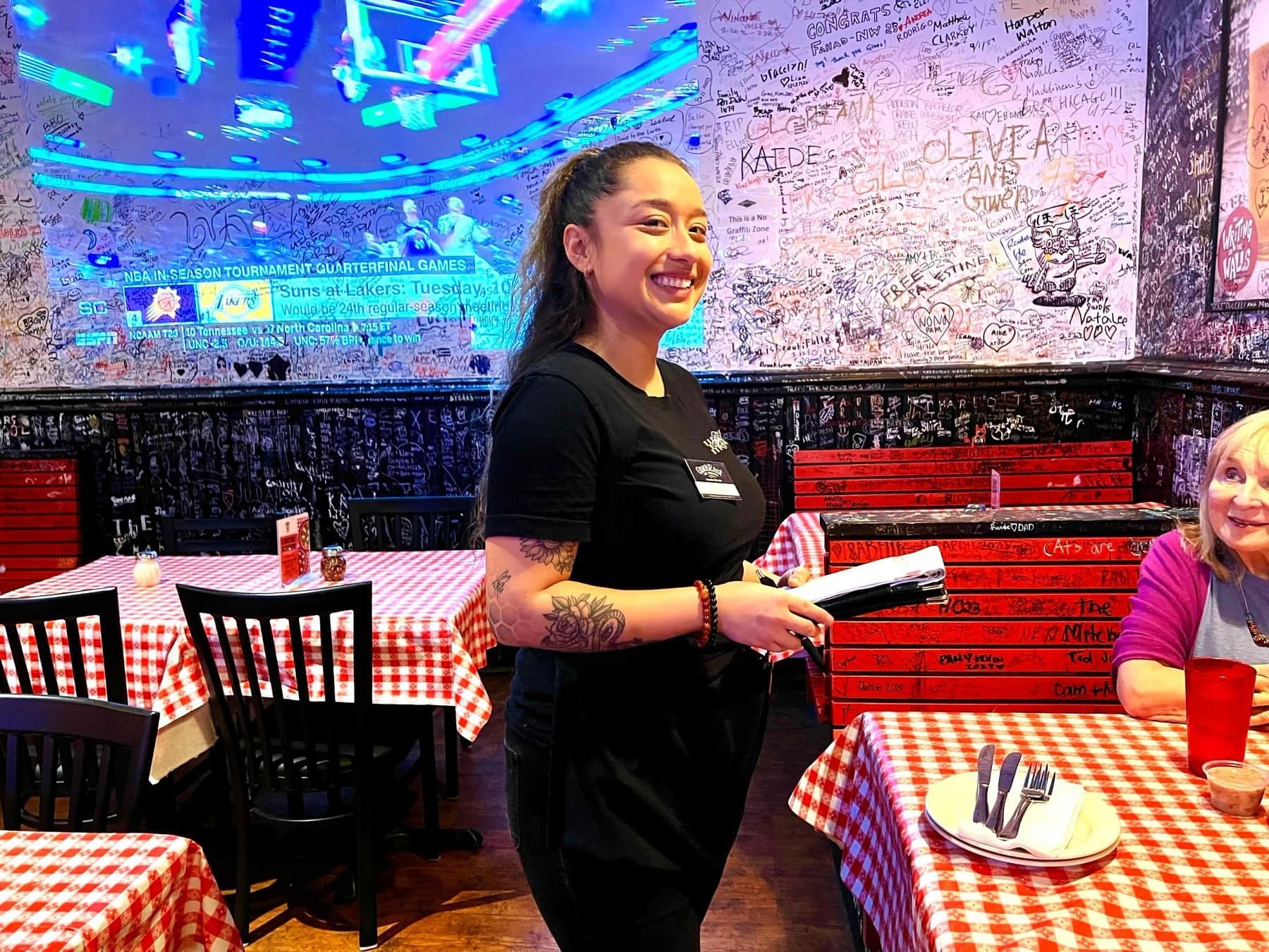 A Gino’s East team member standing in the restaurant
