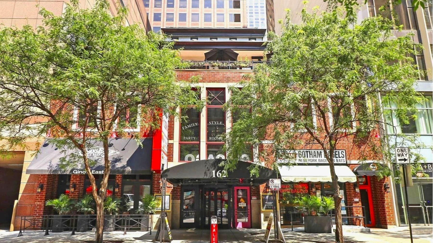 Street view of the brick Gino's East building at 162 E Superior St